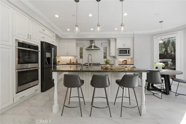 a kitchen with center island table and chairs