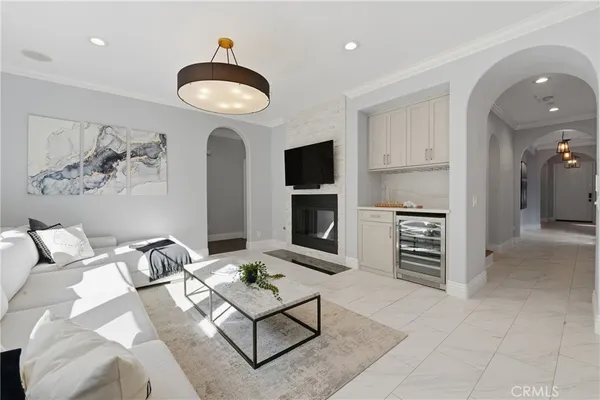 a kitchen with stainless steel appliances granite countertop a table chairs and a refrigerator