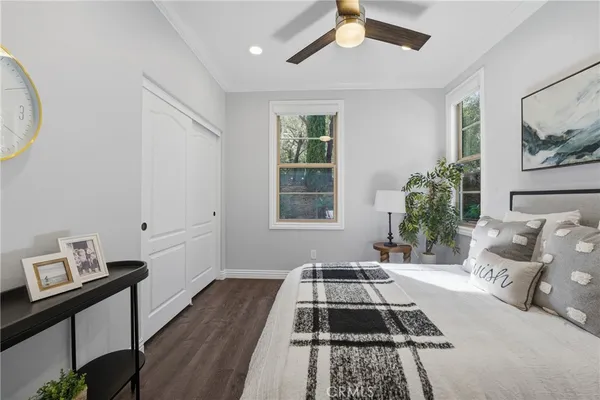 a bedroom with a balcony a bed and a flat screen tv