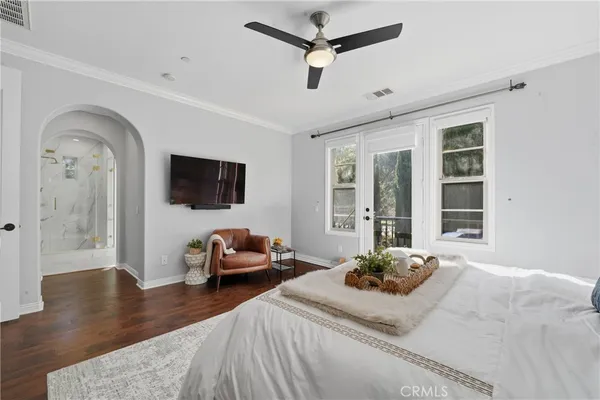 a bedroom with furniture and a wooden floor