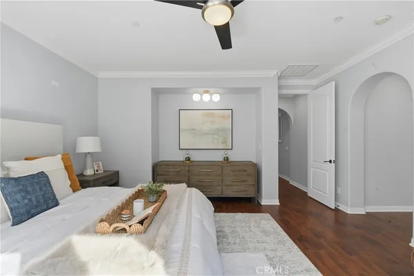 a bedroom with bed and wooden floor