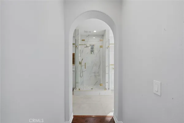 a bathroom with a sink and a mirror with shower