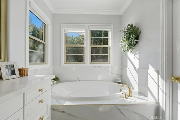 a bathroom with a sink a mirror and a vanity