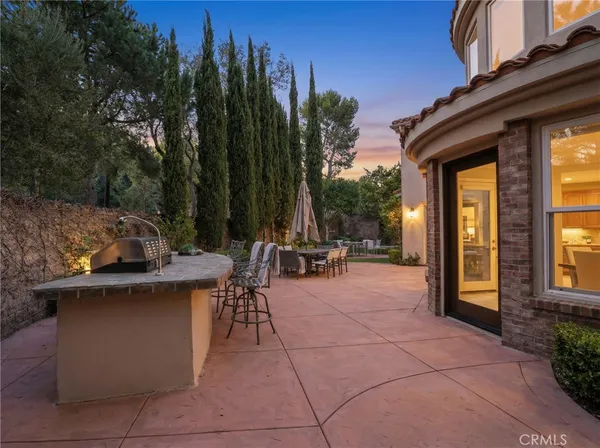 a view of a patio with couches table and chairs and potted plants