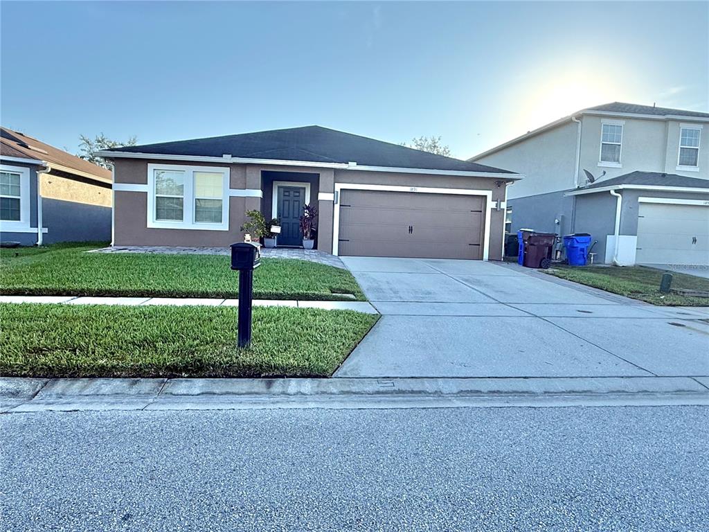 a front view of a house with a yard and garage