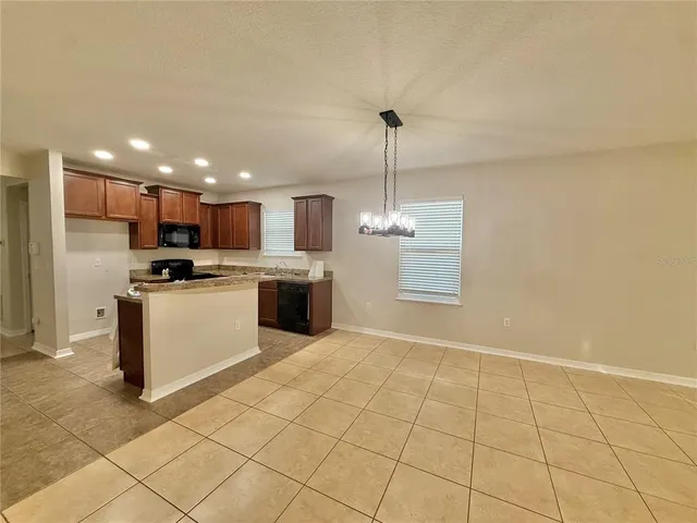 a view of open kitchen with white cabinets