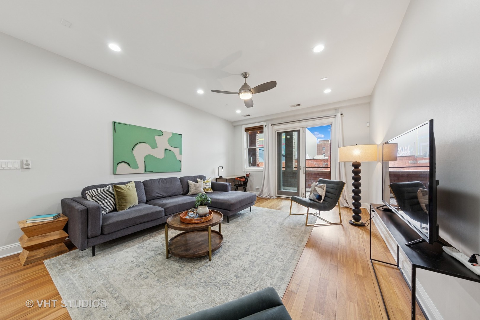 955 West Monroe Street, Unit 2C Chicago, IL 60607 - Photo 2 of 23 a living room with furniture and a flat screen tv