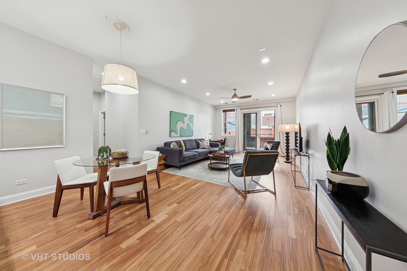 955 West Monroe Street, Unit 2C Chicago, IL 60607 - Photo 6 of 23 a living room with furniture a wooden floor and a potted plant