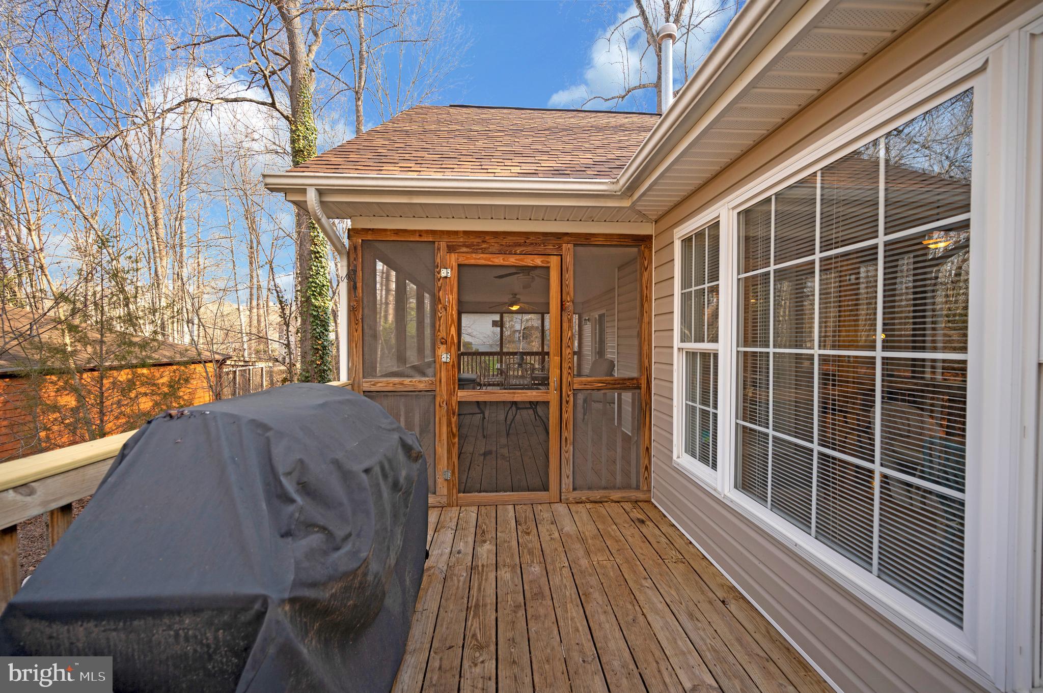 550 Harrison Circle Locust Grove, VA 22508 - Photo 25 of 39 Screened in porch extends to the deck area.