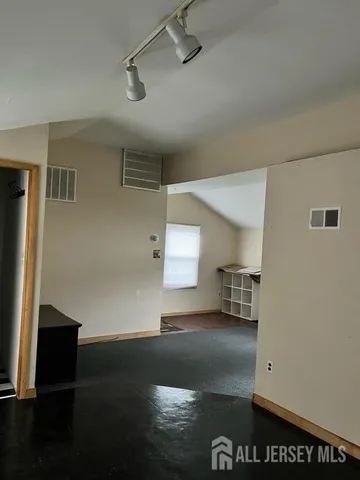 a view of a room with gym equipment and a window