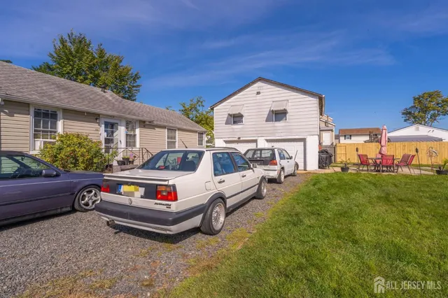 a view of a swimming pool with lawn chairs and a big yard