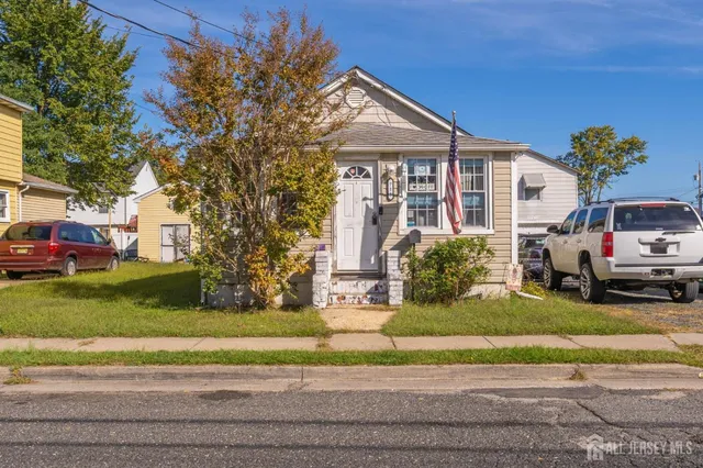 a view of a house with a yard and pathway