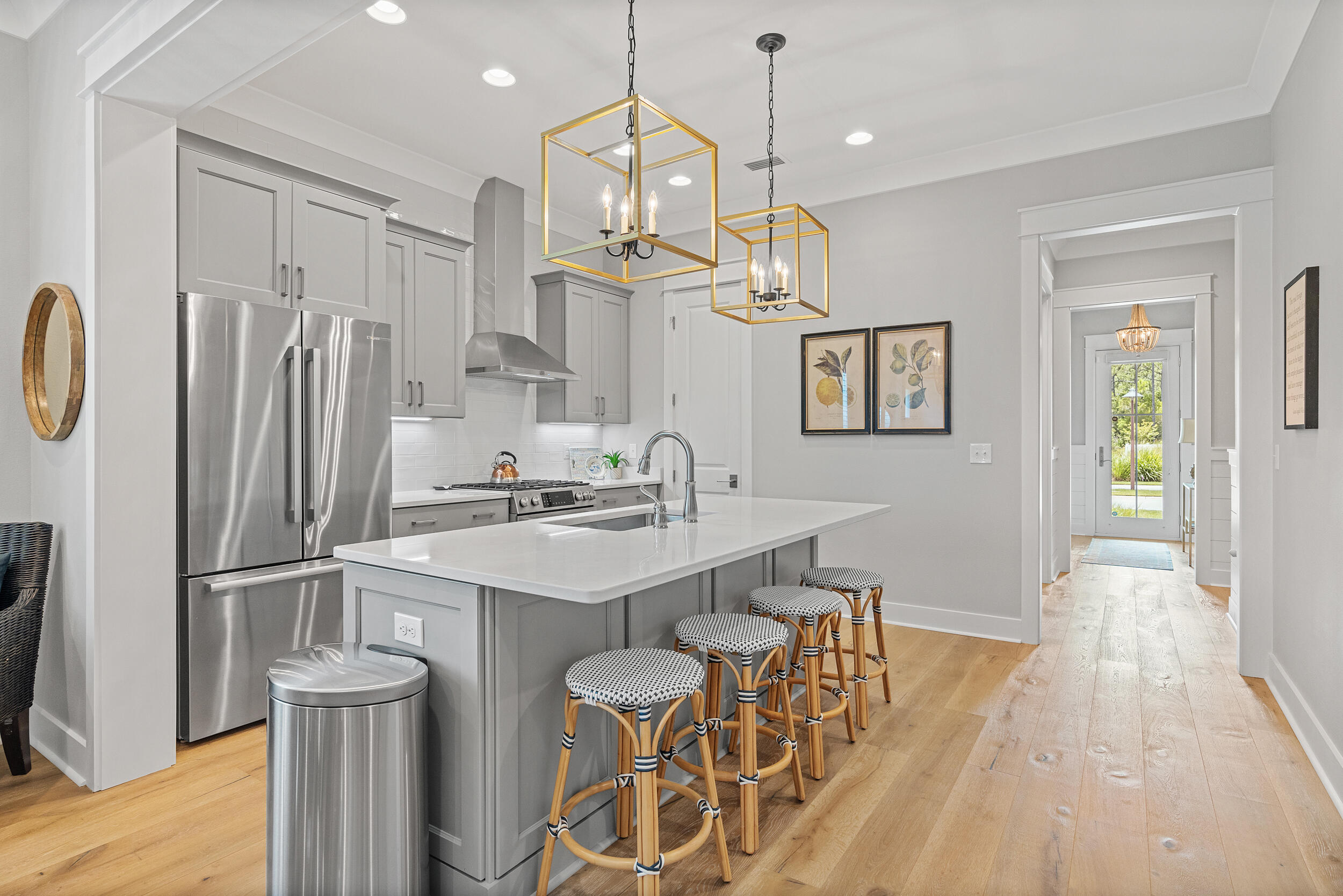 170 Sidecamp Road, Unit LOT 85 Watersound, FL 32461 - Photo 9 of 54 a kitchen with stainless steel appliances a dining table chairs refrigerator and sink