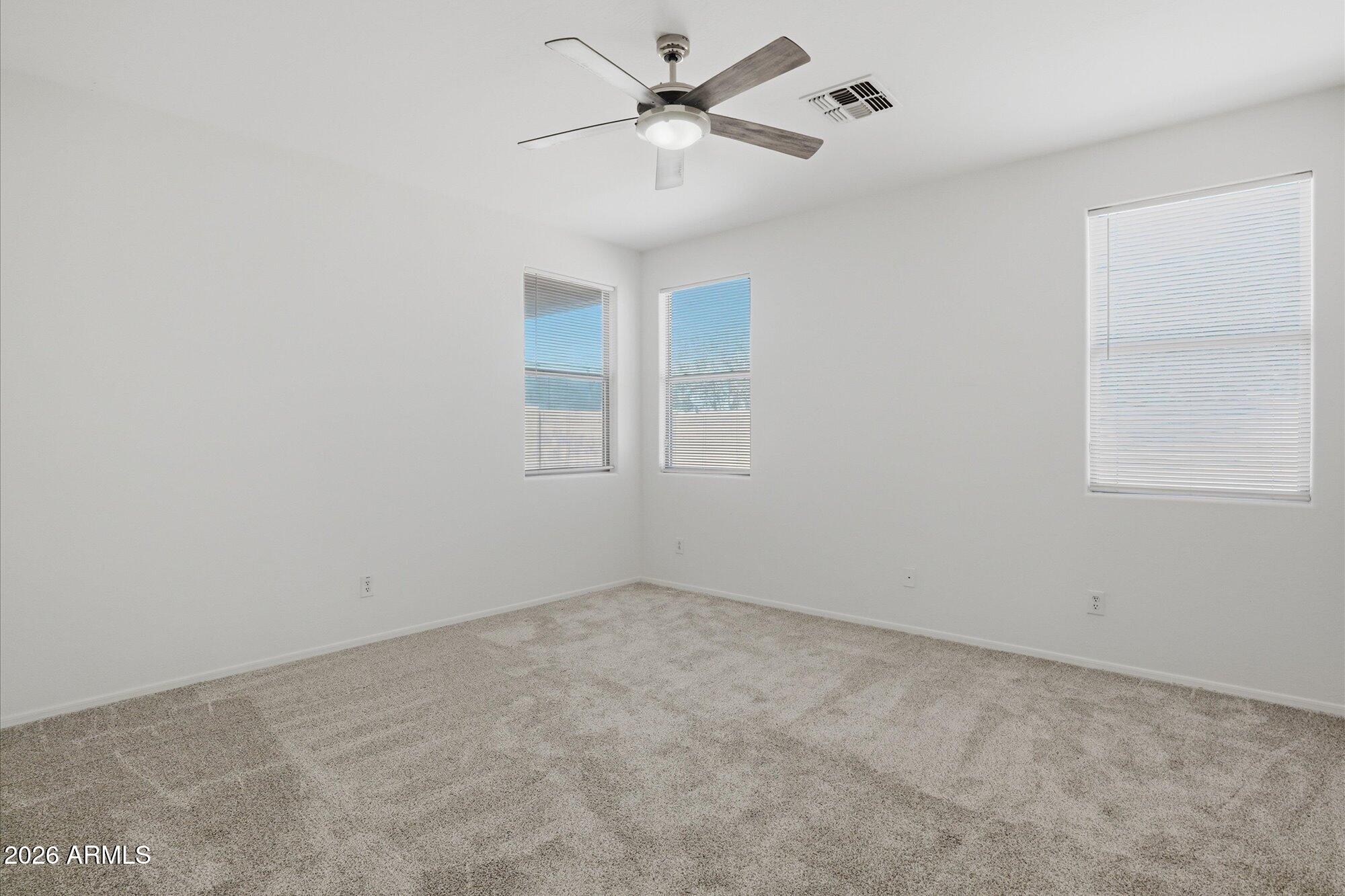 8838 West Payson Road Tolleson, AZ 85353 - Photo 11 of 22 an empty room with a window and a fan