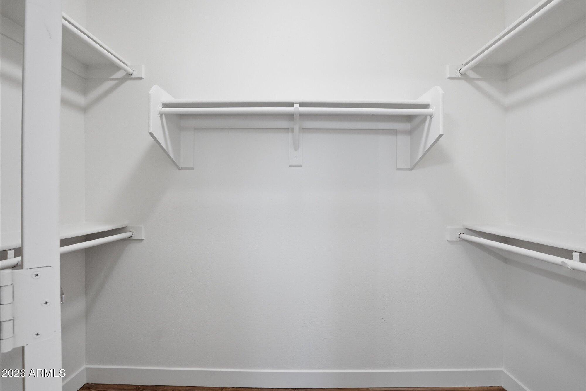 8838 West Payson Road Tolleson, AZ 85353 - Photo 13 of 22 a view of walk in closet with empty racks