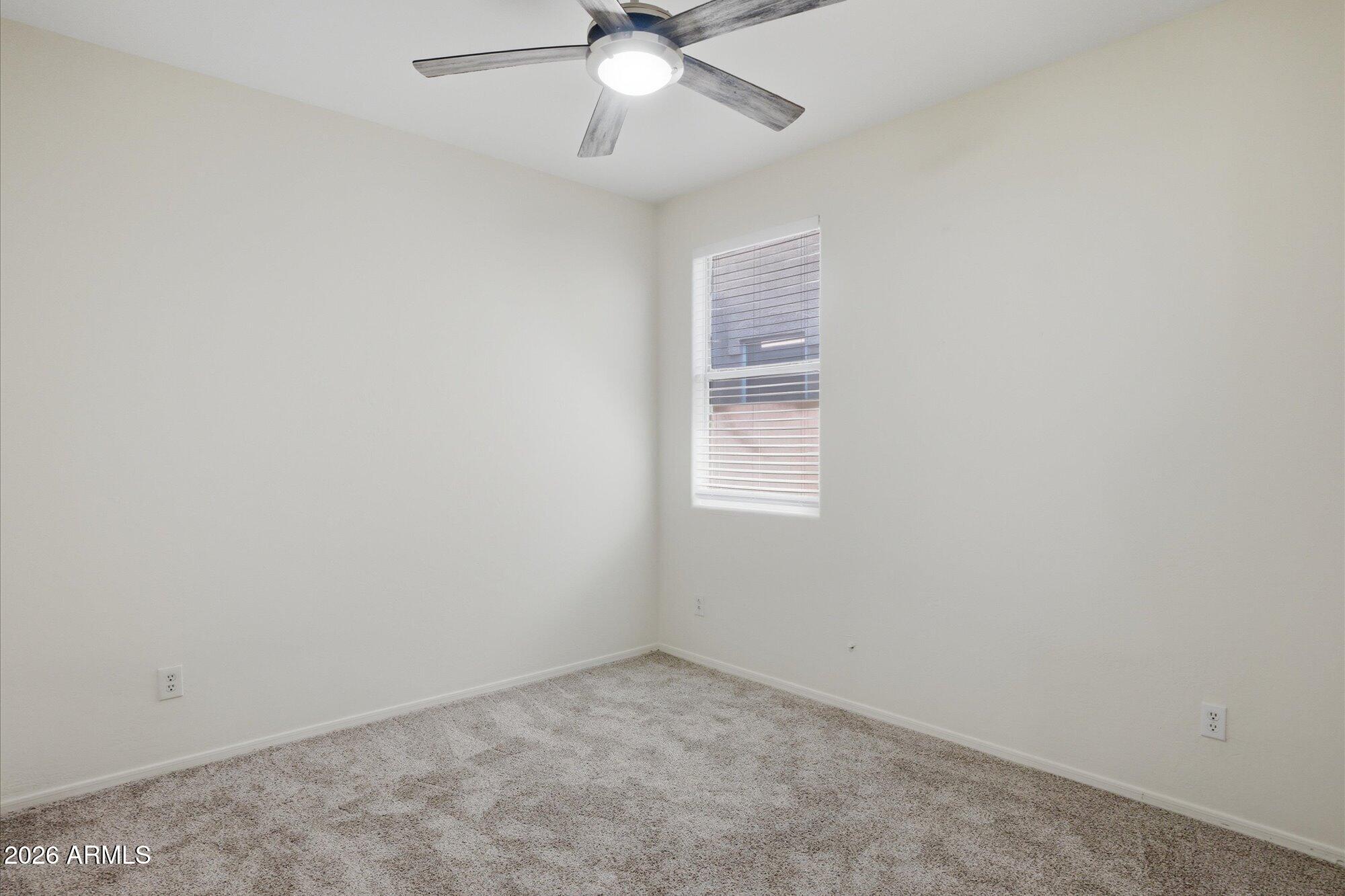8838 West Payson Road Tolleson, AZ 85353 - Photo 14 of 22 an empty room with a window and a fan