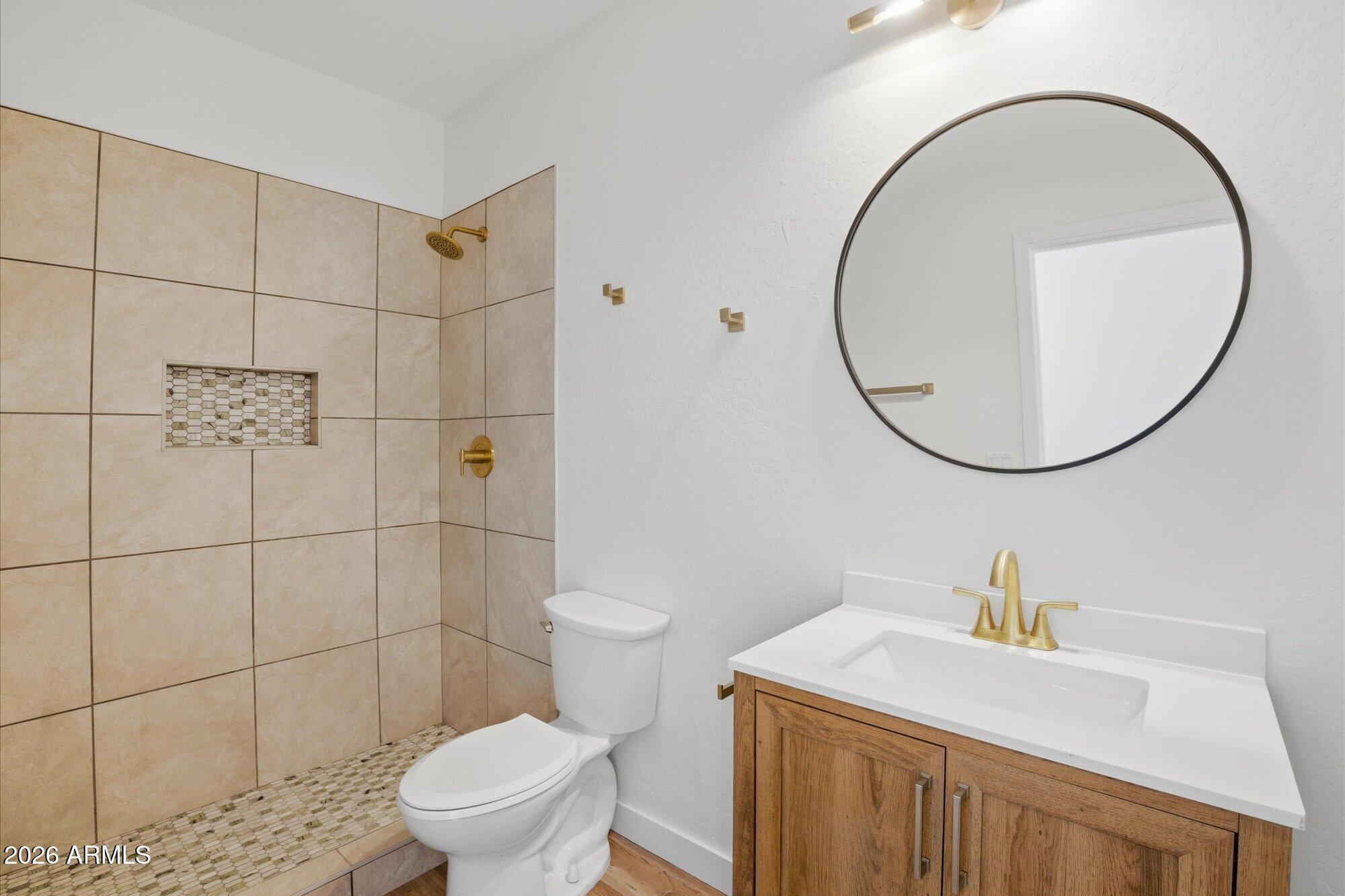 8838 West Payson Road Tolleson, AZ 85353 - Photo 15 of 22 a bathroom with a sink a toilet and a mirror