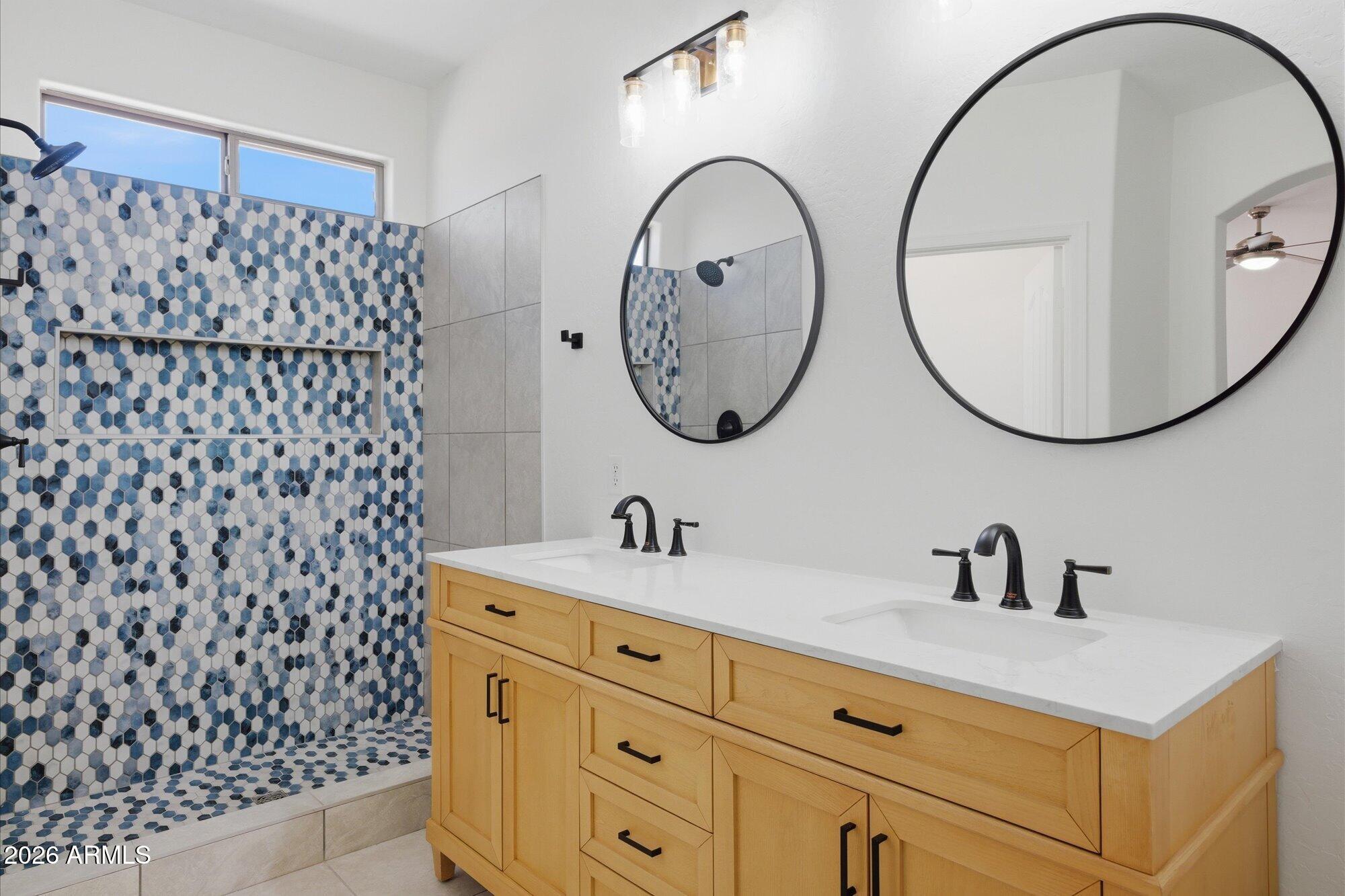 8838 West Payson Road Tolleson, AZ 85353 - Photo 8 of 22 a bathroom with a sink and a mirror
