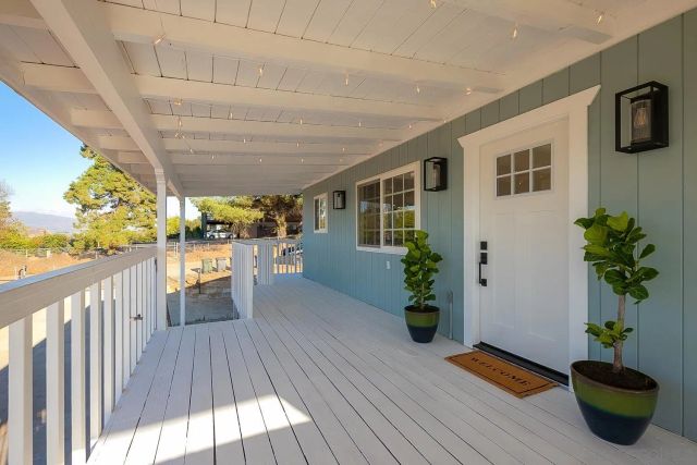 a view of wooden floor and a chandelier fan in a room