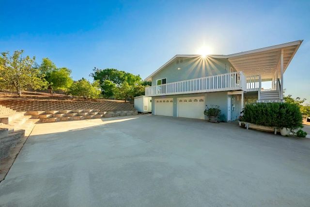 a kitchen with stainless steel appliances granite countertop a stove a sink and a white cabinets