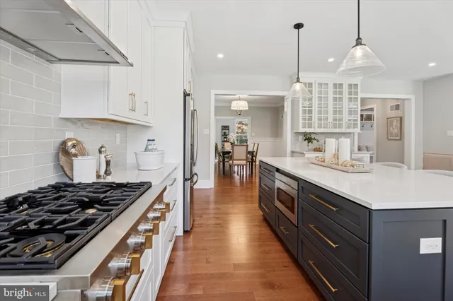 a kitchen with kitchen island a sink stove and cabinets