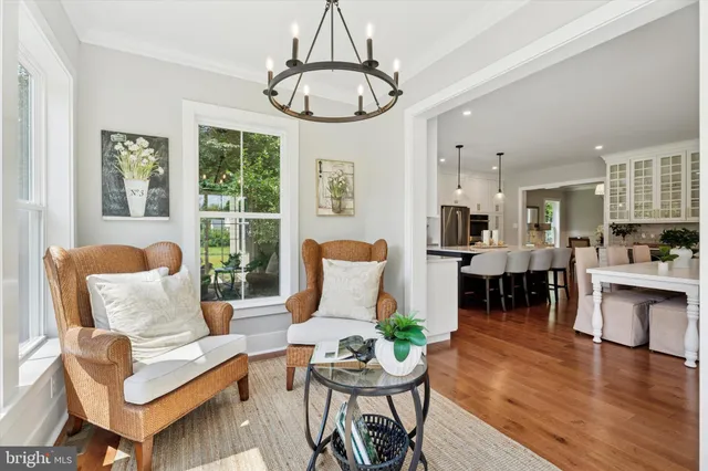 a living room with furniture a dining table and a window