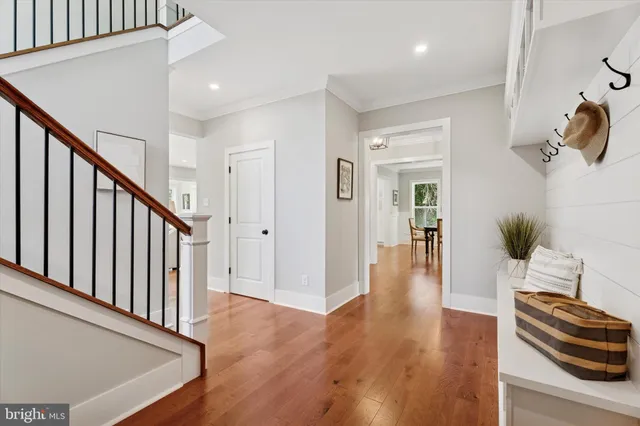 a view of a hallway with wooden floor and staircase