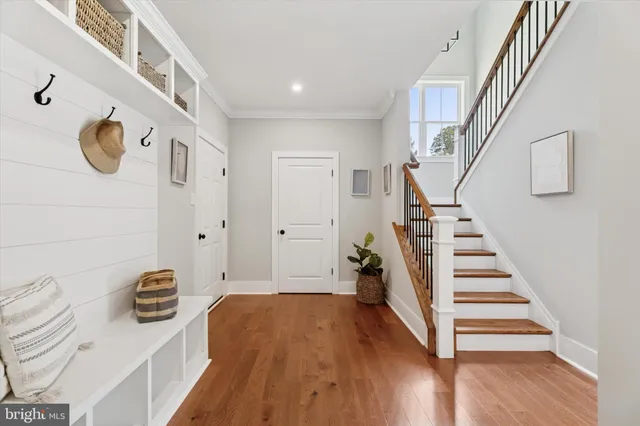 a view of entryway with stairs and wooden floor
