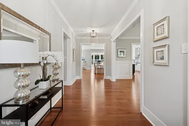 a hallway with wooden floor and lots of windows
