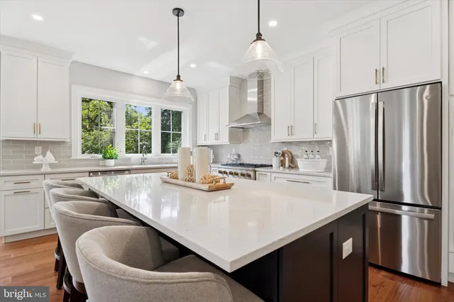 a kitchen with refrigerator cabinets and a large window