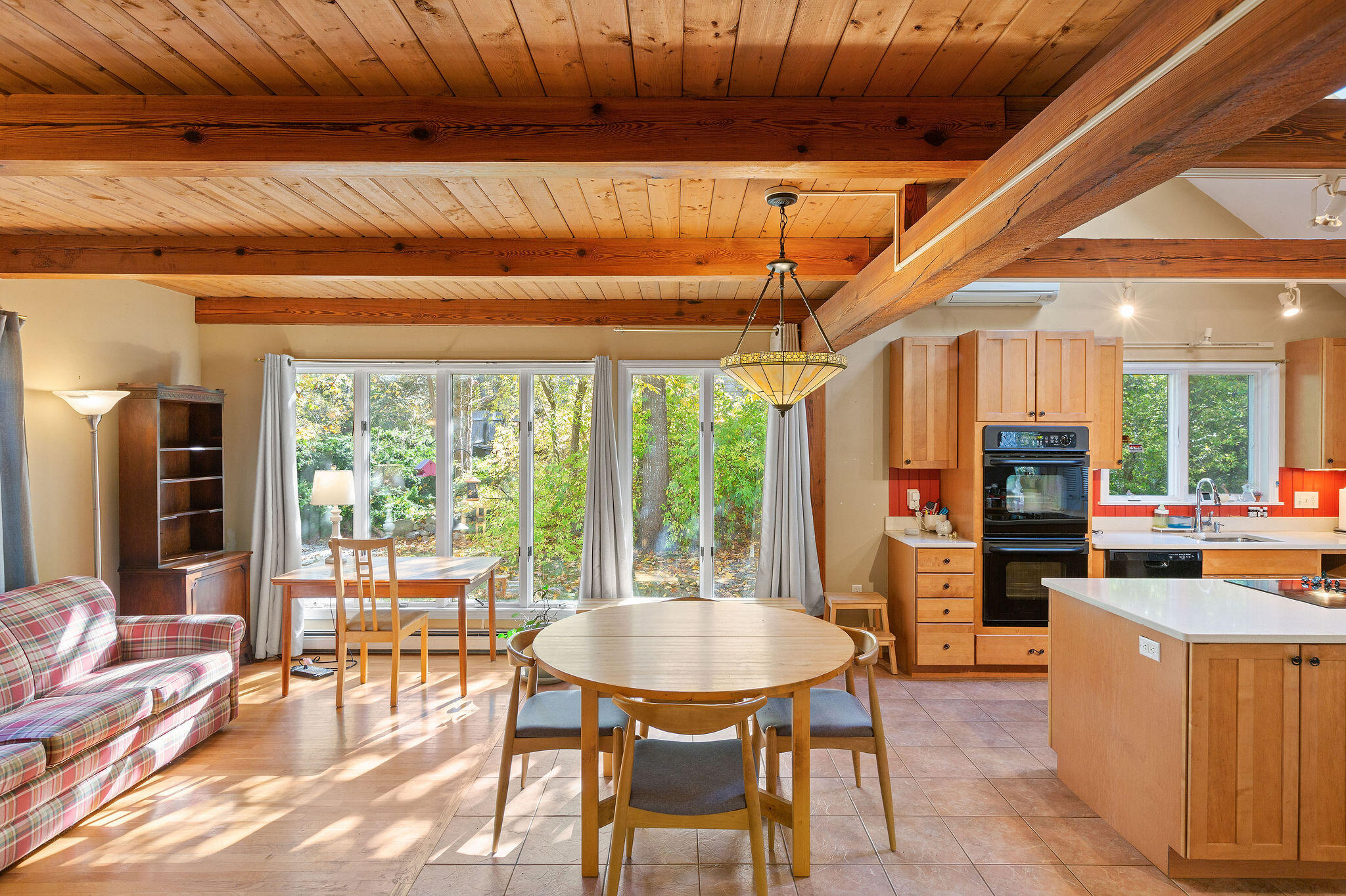 274 Commons Way Brewster, MA 02631 - Photo 4 of 32 a dining room with furniture a chandelier and wooden floor