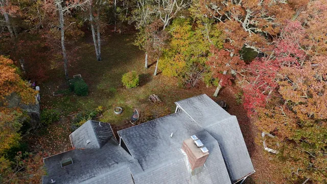 an aerial view of a house with yard