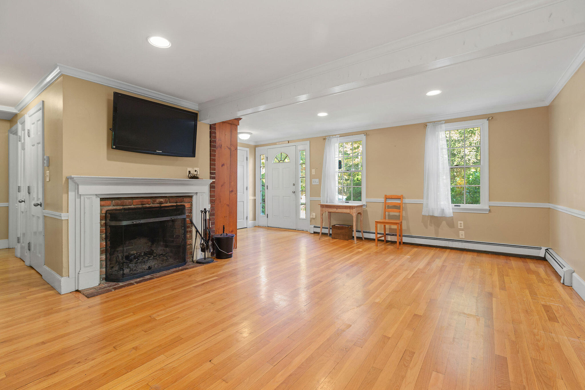 274 Commons Way Brewster, MA 02631 - Photo 8 of 32 a view of a livingroom with an empty space and a fireplace
