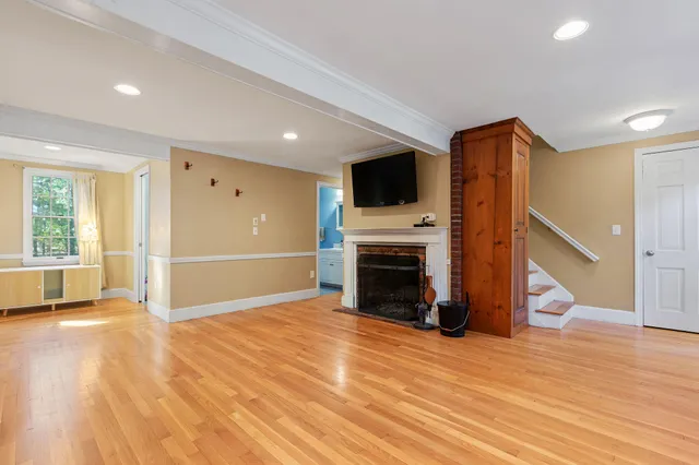 a view of livingroom with an empty space and a fireplace