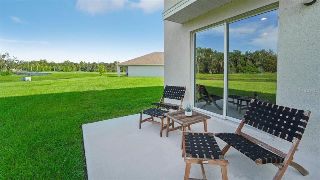 17493 Acorn Drop Road Land O Lakes, FL 34638 - Photo 22 of 23 a view of a patio with a yard