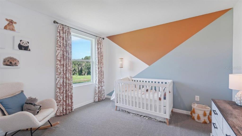 17493 Acorn Drop Road Land O Lakes, FL 34638 - Photo 10 of 23 a bedroom with furniture and a window