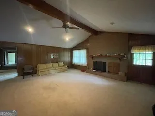 an empty room with furniture and a fireplace