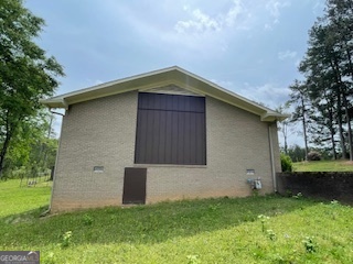 1478 Mineral Springs Road Elberton, GA 30635 - Photo 28 of 30 a brick house with a small yard and large trees