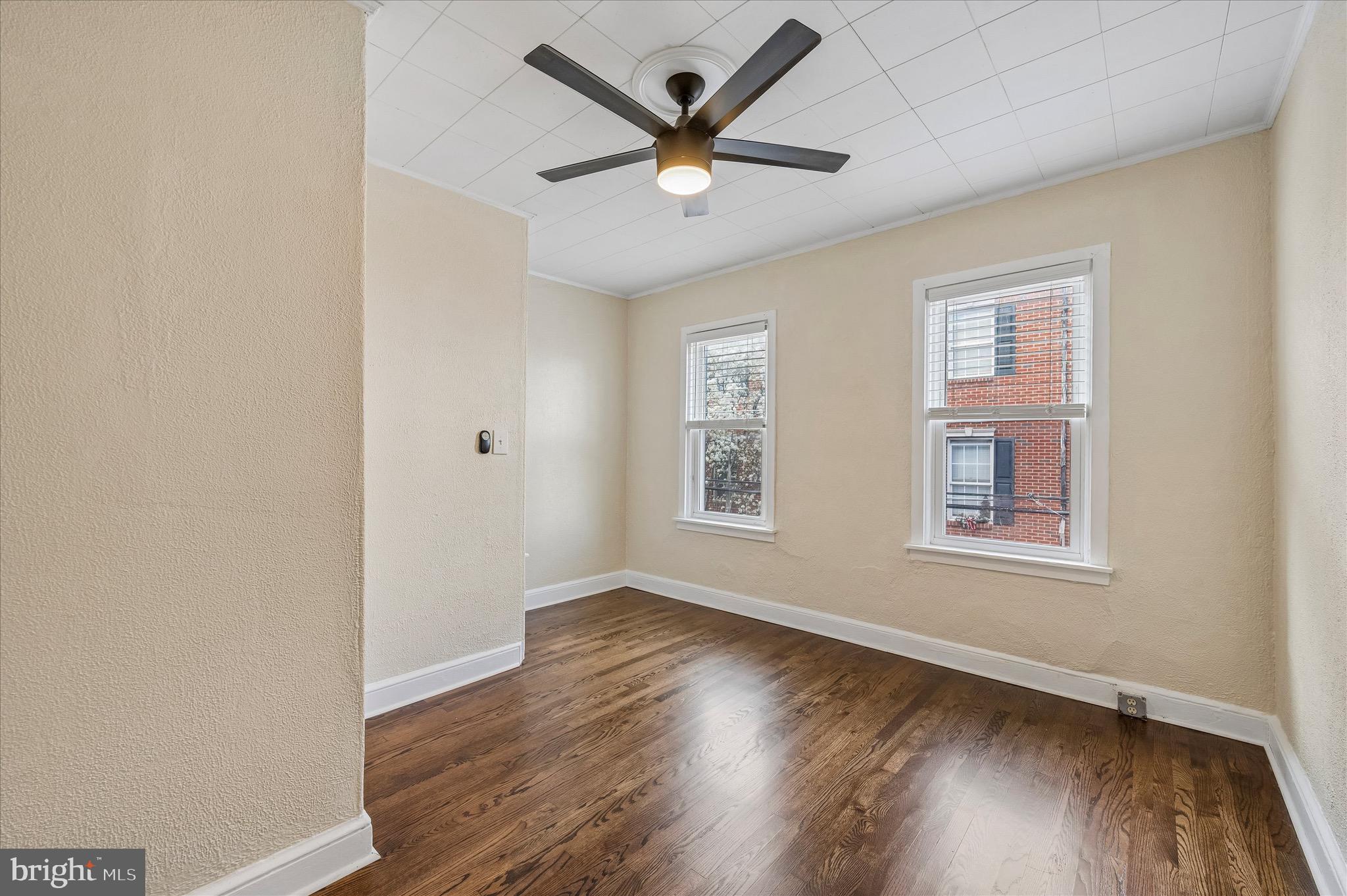 2531 Webb Street Philadelphia, PA 19125 - Photo 11 of 15 an empty room with wooden floor ceiling fan and windows