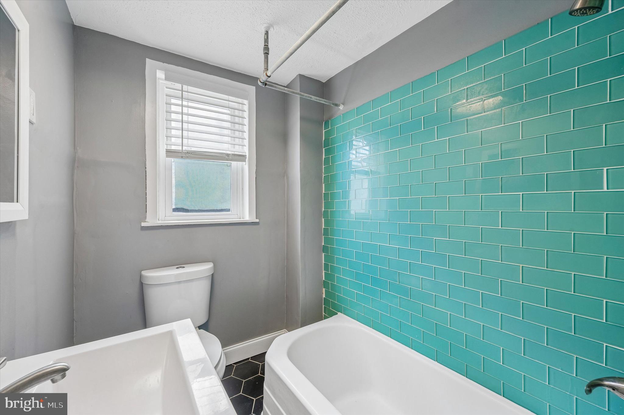 2531 Webb Street Philadelphia, PA 19125 - Photo 12 of 15 a bathroom with a toilet a sink and mirror