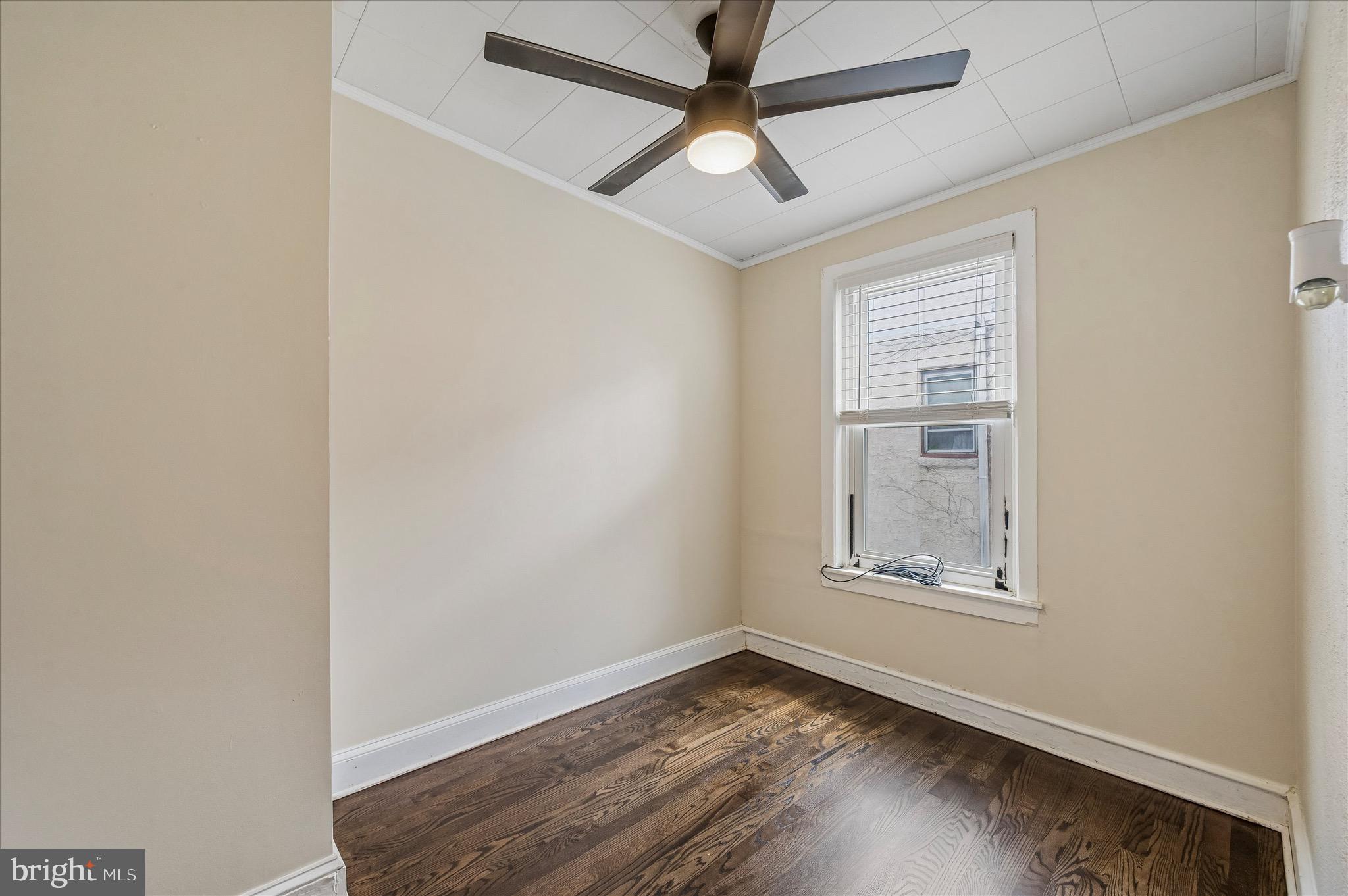 2531 Webb Street Philadelphia, PA 19125 - Photo 13 of 15 an empty room with wooden floor ceiling fan and windows