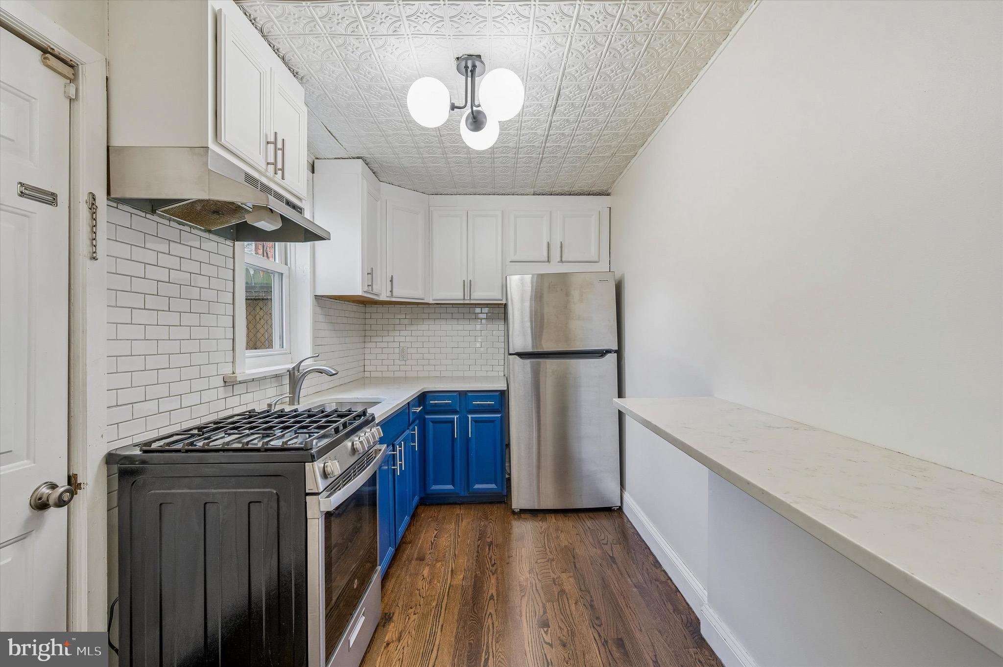 2531 Webb Street Philadelphia, PA 19125 - Photo 7 of 15 a kitchen with stainless steel appliances granite countertop a stove a refrigerator a sink dishwasher and wooden cabinets with wooden floor