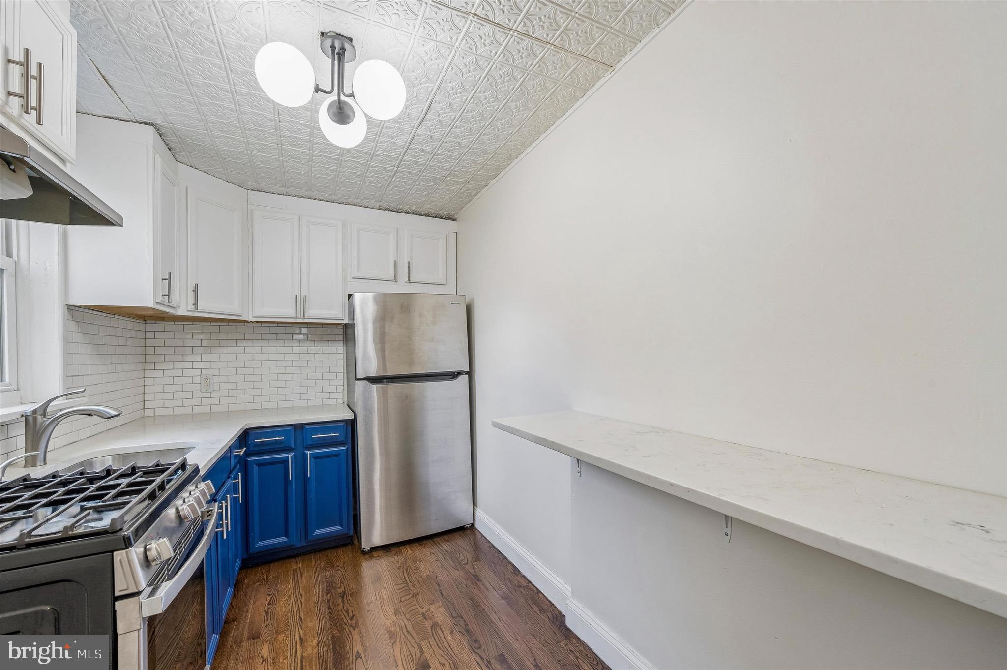 2531 Webb Street Philadelphia, PA 19125 - Photo 9 of 15 a kitchen with a stove a refrigerator and cabinets
