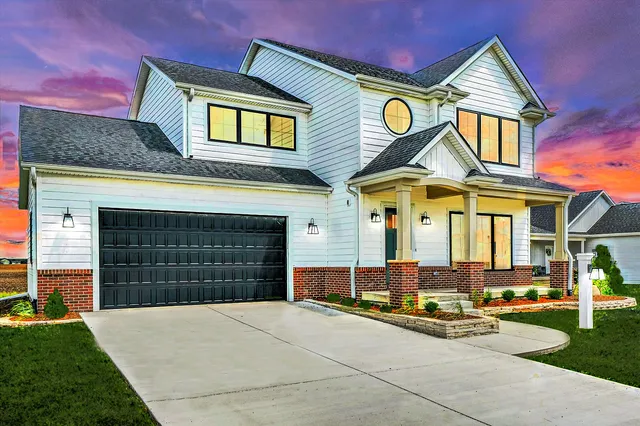 a front view of a house with a yard and garage