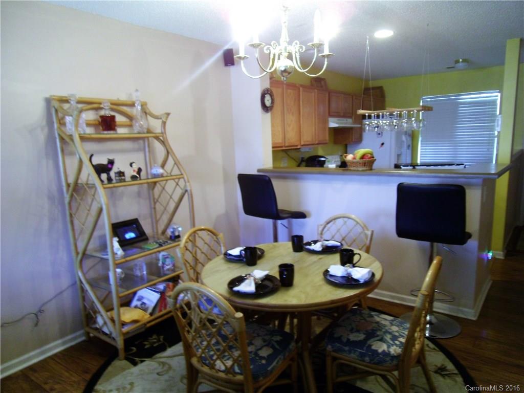 8214 Rudolph Road, Unit 8214 Charlotte, NC 28216 - Photo 8 of 19 a view of a dining room with furniture and a chandelier
