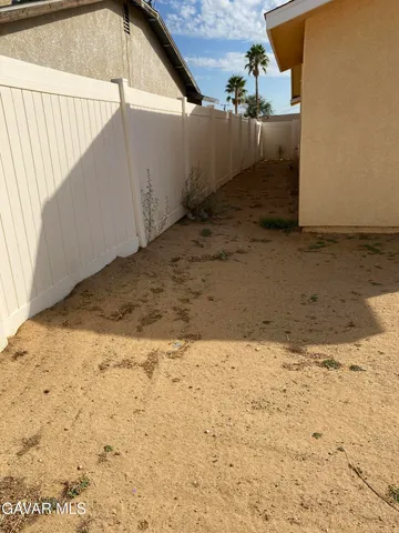 a view of a backyard of the house