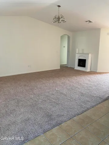 a view of empty room with a fireplace