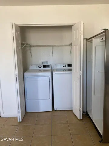 a utility room with cabinets washer and dryer