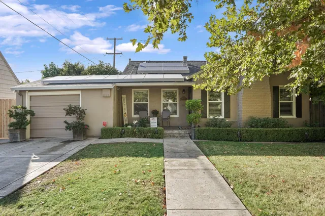 a front view of a house with garden