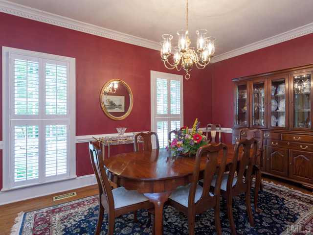 1917 Prescott Place Raleigh, NC 27615 - Photo 11 of 25 The spacious dining room features dentil crown molding, chair rail, plantation shutters, and hardwood floors. Dining Room